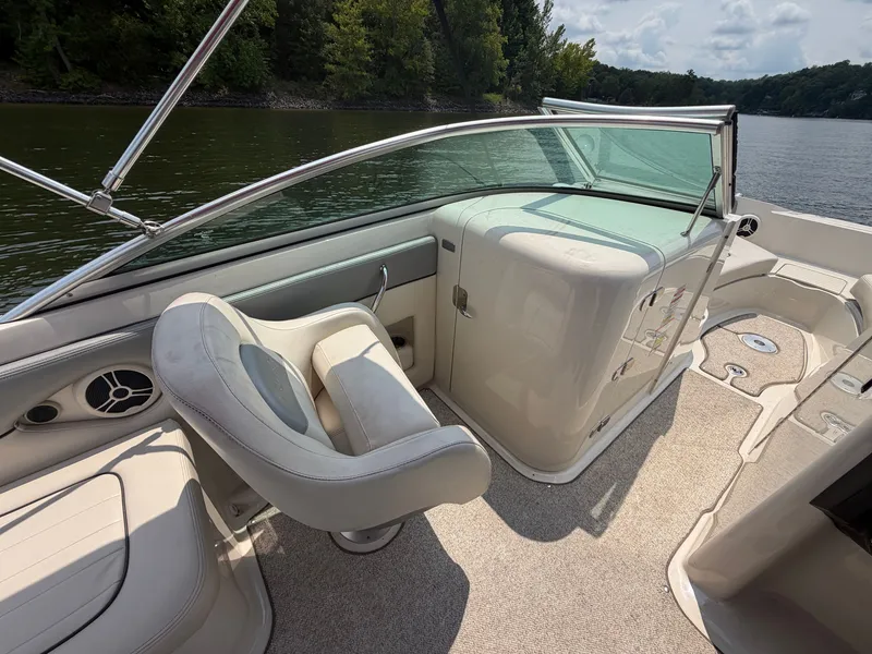 Slide: The Image of The image shows the cockpit of a 2009 Sea Ray 230 Sundeck boat with beige interior. - 10