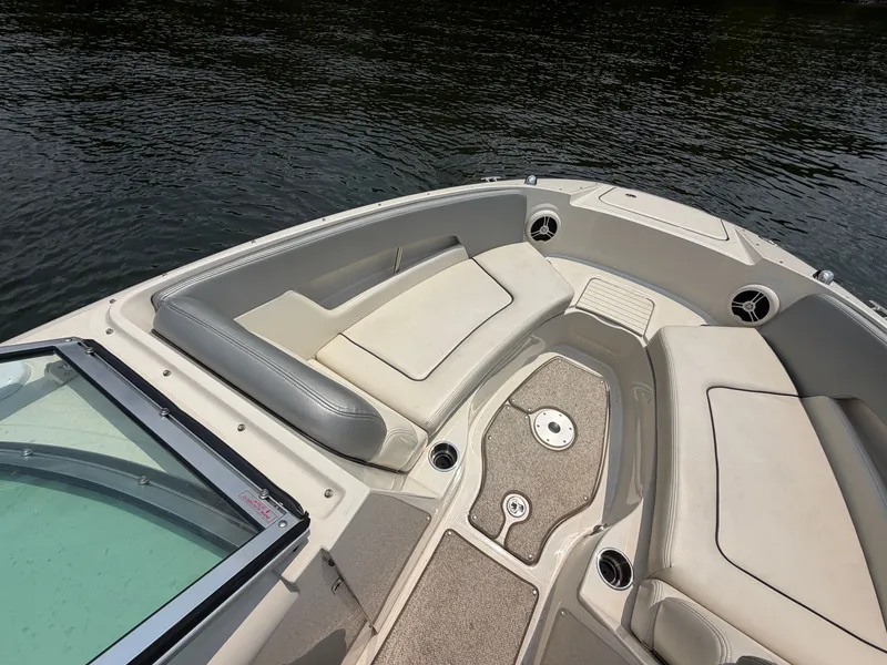 Slide: The Image of The image shows the bow area of a 2009 Sea Ray 230 Sundeck boat with beige upholstery. - 8
