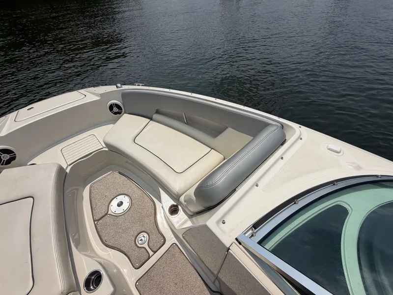 Slide: The Image of The image shows the bow of a 2009 Sea Ray 230 Sundeck boat with beige upholstery. - 7