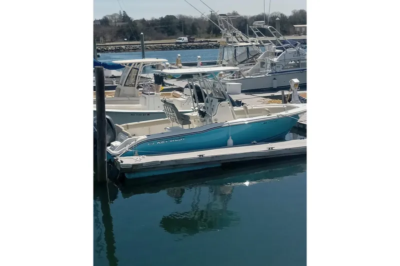 Slide: The Image of 2024 Key West 239 FS boat docked in a marina, surrounded by other vessels. - 7