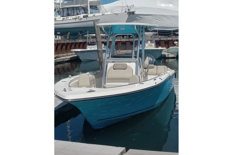 Slide: The Image of 2024 Key West 239 FS boat docked, featuring a sleek blue hull and modern design. - 6