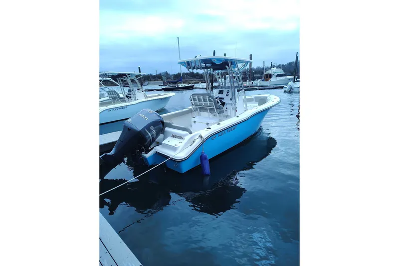 The Image of 2024 Key West 239 FS boat docked in marina, featuring Yamaha outboard motor. - 5