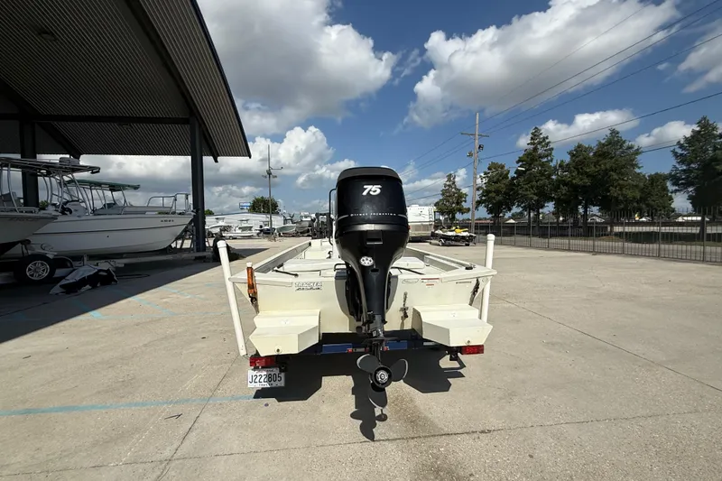 Slide: The Image of 2010 Tracker Grizzly 1860 SC Blind Duck Edition boat with 75 HP motor in a marina. - 8