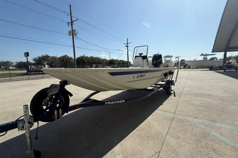 Slide: The Image of 2010 Tracker Grizzly 1860 SC Blind Duck Edition boat on trailer in sunny outdoor setting. - 5