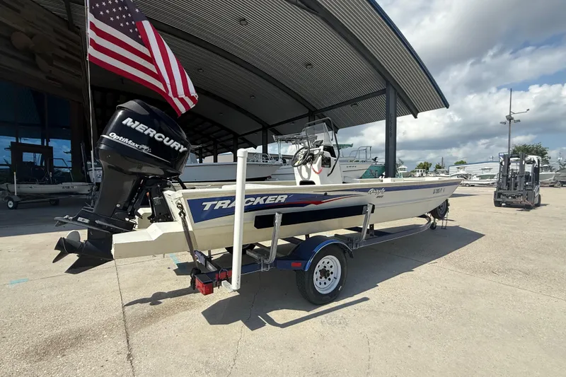 Slide: The Image of 2010 Tracker Grizzly 1860 SC Blind Duck Edition boat on trailer, with Mercury outboard motor. - 3