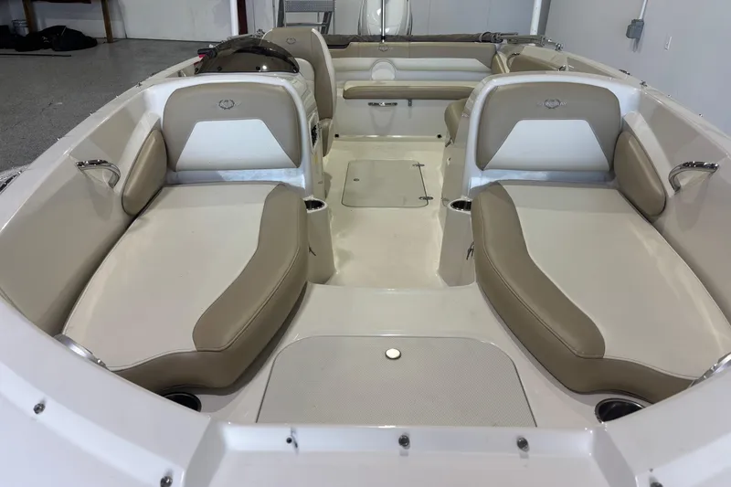 Slide: The Image of 2017 Stingray 182 SC boat interior with beige seating and spacious layout. - 10