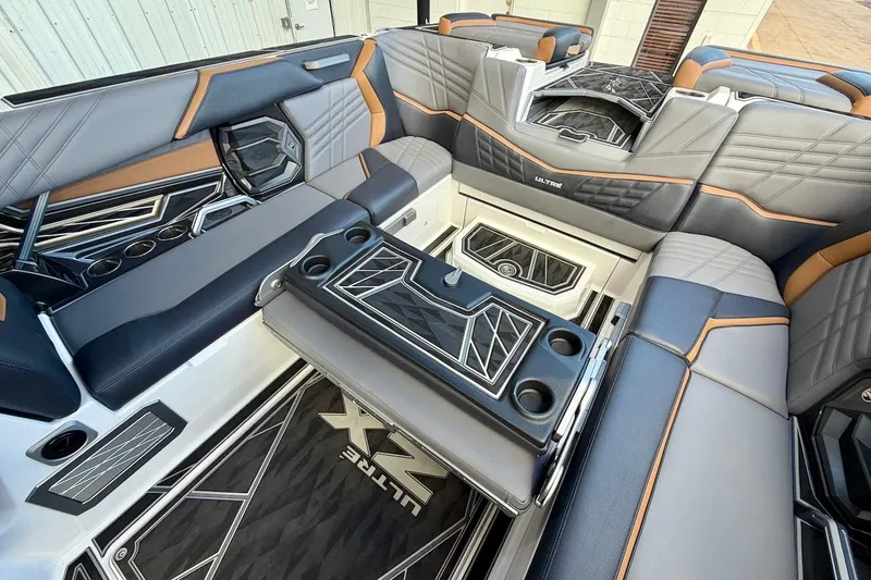 Slide: The Image of Luxurious interior of 2025 Tigé Ultré 25ZX boat with stylish seating and cup holders. - 29