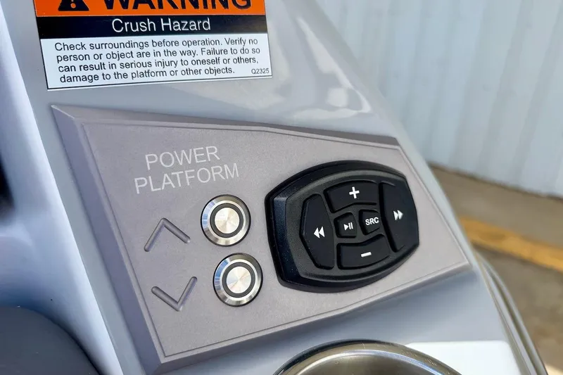 Slide: The Image of Control panel of 2025 Tigé Ultré 25ZX boat with warning label and buttons. - 52