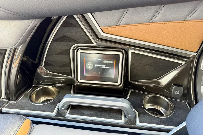 Slide: The Image of 2025 Tigé Ultré 25ZX dashboard with touchscreen controls and cup holders. - 26