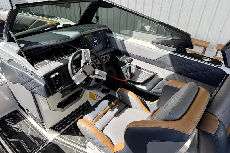 Slide: The Image of Interior of 2025 Tigé Ultré 25ZX boat with modern dashboard and steering wheel. - 15