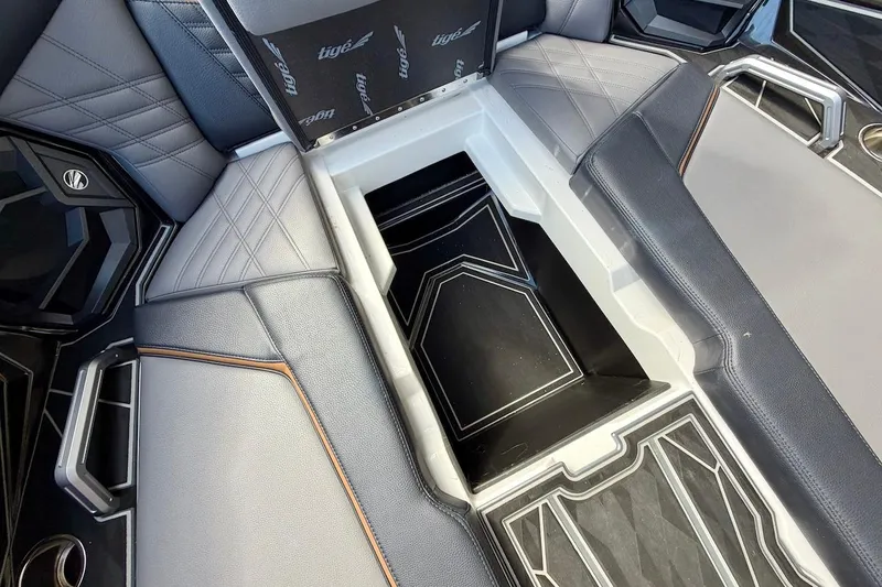 Slide: The Image of Interior seating and storage of 2025 Tigé Ultré 25ZX boat, featuring sleek design and premium materials. - 22