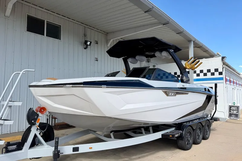 Slide: The Image of 2025 Tigé Ultré 25ZX boat on trailer, parked outside a building. - 3