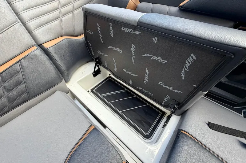 Slide: The Image of 2025 Tigé Ultré 25ZX boat interior storage compartment with open seat cushion. - 33