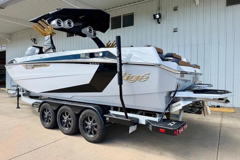 Slide: The Image of 2025 Tigé Ultré 25ZX boat on a trailer, showcasing sleek design and modern features. - 4