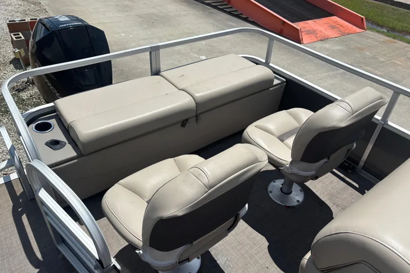 Slide: The Image of 2020 Sun Tracker Fishin' Barge 22 XP3 interior with seating and storage. - 5