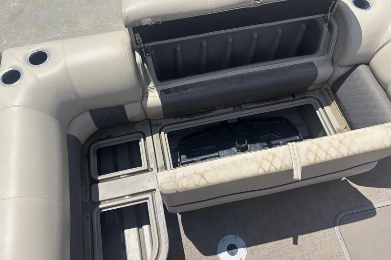 Slide: The Image of 2020 Sun Tracker Fishin' Barge 22 XP3 interior storage compartments with cup holders. - 10
