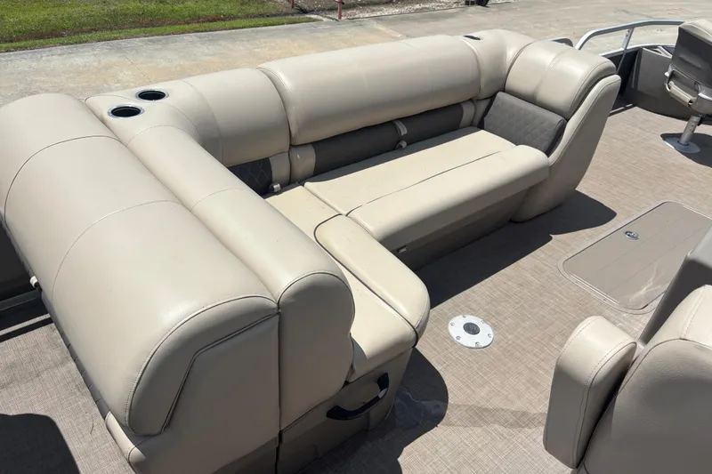 Slide: The Image of 2020 Sun Tracker Fishin' Barge 22 XP3 interior with beige seating and cup holders. - 9