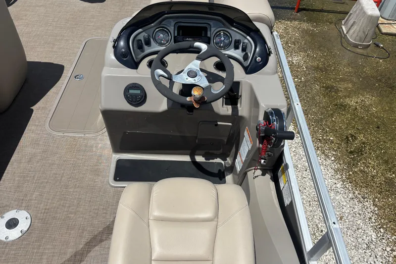 Slide: The Image of 2020 Sun Tracker Fishin' Barge 22 XP3 helm with steering wheel and controls. - 14