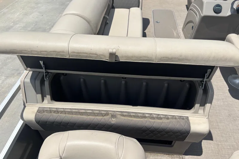 Slide: The Image of 2020 Sun Tracker Fishin' Barge 22 XP3 storage compartment with open seat cushion. - 12