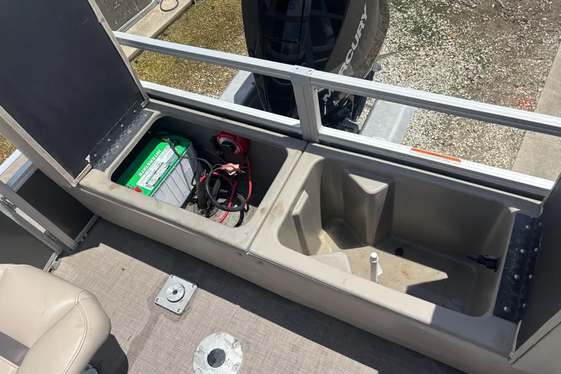 Slide: The Image of 2020 Sun Tracker Fishin' Barge 22 XP3 battery compartment and storage area. - 6