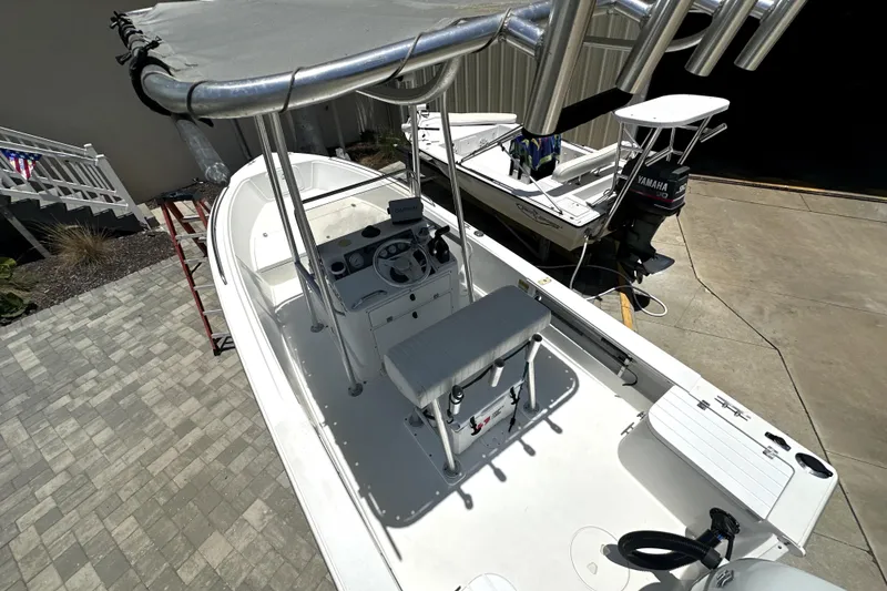 Slide: The Image of 2004 Aquasport 175 Osprey boat with T-top and Yamaha outboard motor in driveway. - 6