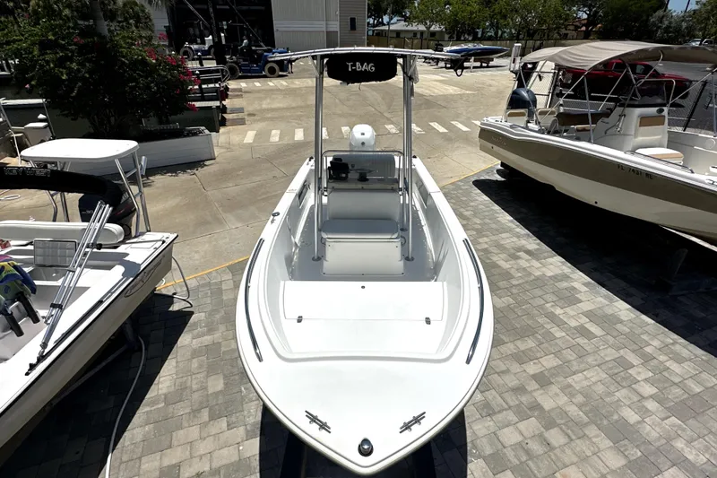 Slide: The Image of 2004 Aquasport 175 Osprey boat docked, surrounded by other boats in a marina. - 7