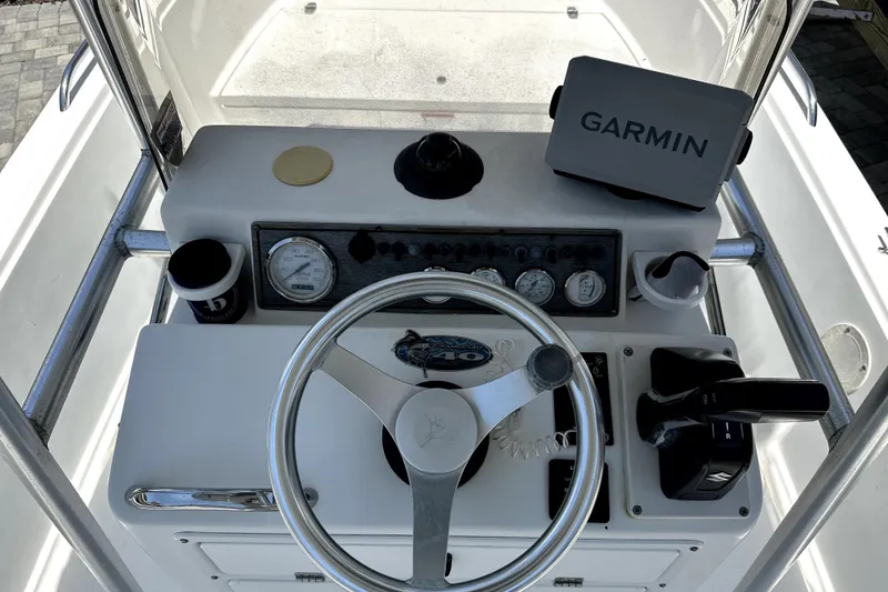 Slide: The Image of 2004 Aquasport 175 Osprey boat dashboard with Garmin GPS and steering wheel. - 10