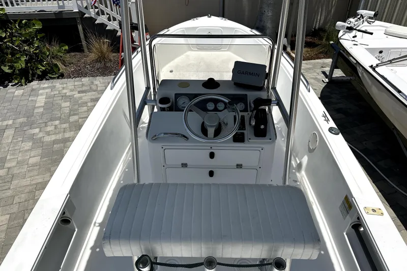 Slide: The Image of 2004 Aquasport 175 Osprey boat interior with steering wheel and Garmin navigation system. - 9