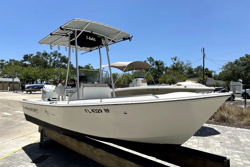 Slide: The Image of 2004 Aquasport 175 Osprey boat on display, featuring a T-top and sleek design. - 3