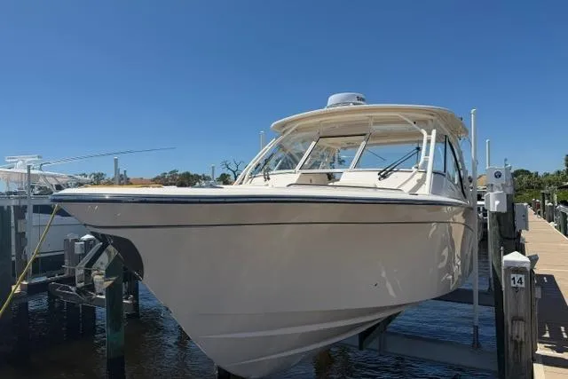 Slide: The Image of 2024 Grady-White Freedom 335 boat docked under clear blue sky. - 3