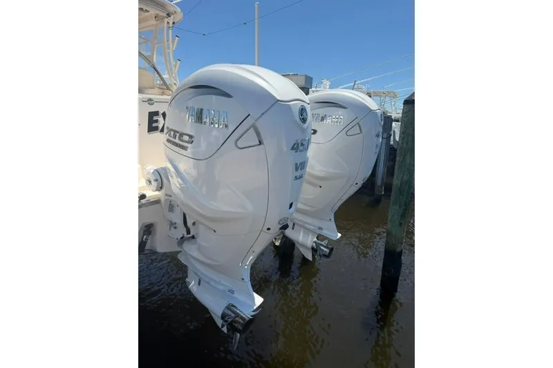 Slide: The Image of Twin Yamaha outboard engines on a 2024 Grady-White Freedom 335 boat, docked in water. - 16