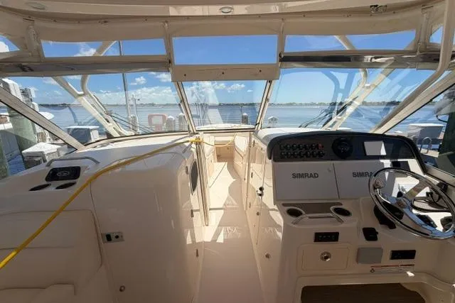 Slide: The Image of 2024 Grady-White Freedom 335 boat interior with dual Simrad displays and ocean view. - 7