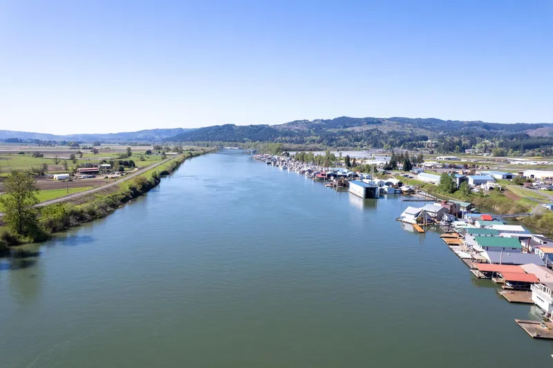 Slide: The Image of Aerial view of a river with boathouses, including a 1985 Custom Larson Boathouse. - 23