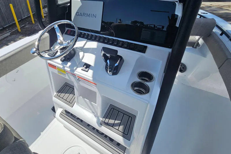 Slide: The Image of 2027 Sea Hunt Ultra 245 SE boat console with Garmin display and steering wheel. - 17