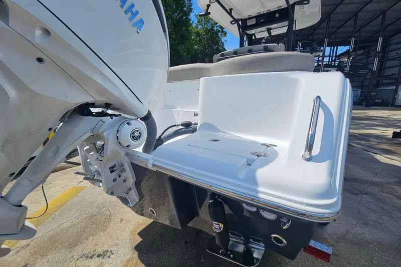Slide: The Image of 2027 Sea Hunt Ultra 245 SE boat with Yamaha outboard motor, docked in a marina. - 7