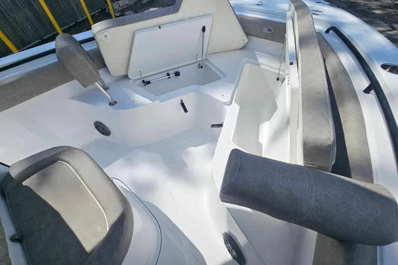 Slide: The Image of Interior of 2027 Sea Hunt Ultra 245 SE boat, featuring seating and storage compartments. - 27