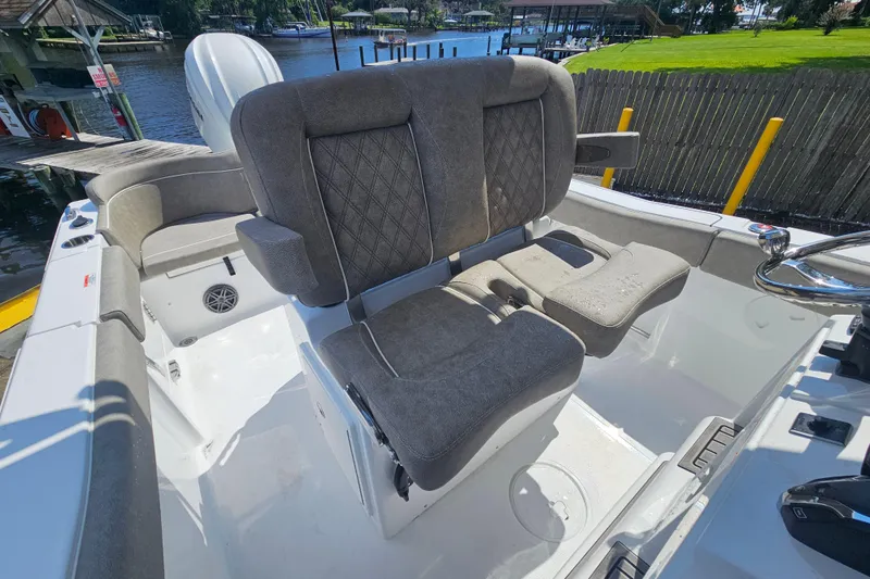 Slide: The Image of 2027 Sea Hunt Ultra 245 SE boat interior with cushioned seating and steering wheel. - 16