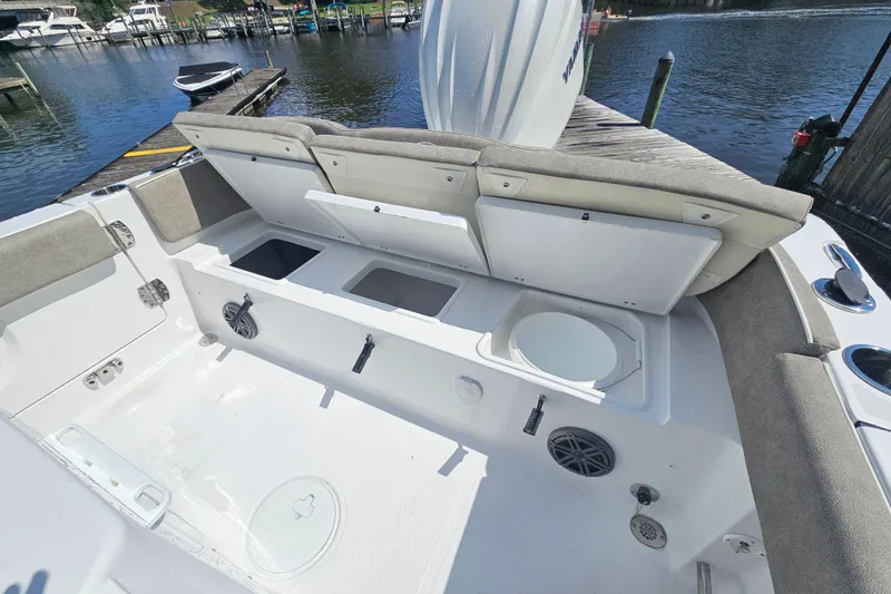 Slide: The Image of 2027 Sea Hunt Ultra 245 SE boat interior with open storage compartments and seating. - 11