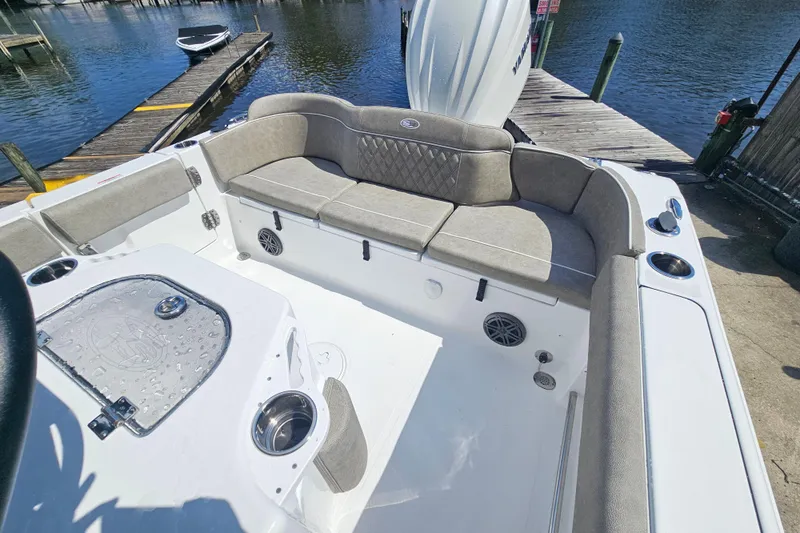 Slide: The Image of Interior view of a 2027 Sea Hunt Ultra 245 SE boat with cushioned seating. - 10