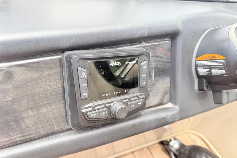 Slide: The Image of 2023 Bentley Pontoons 220 Elite Rear Lounger dashboard with Wet Sounds audio system. - 18