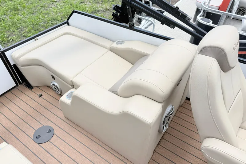 Slide: The Image of 2023 Bentley Pontoons 220 Elite Rear Lounger with beige seating and wood-style flooring. - 14