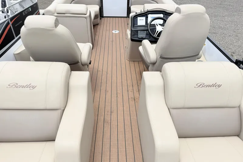 Slide: The Image of 2023 Bentley Pontoons 220 Elite Rear Lounger with luxurious beige seating and sleek design. - 16