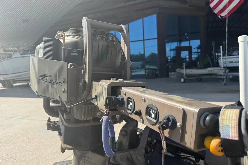 Slide: The Image of Pro-Drive 2048 outboard motor, 2017 model, in a boatyard setting with American flag. - 11