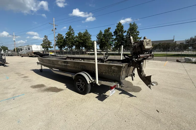 Slide: The Image of 2017 Pro-Drive 2048 boat on trailer in parking lot under clear sky. - 7