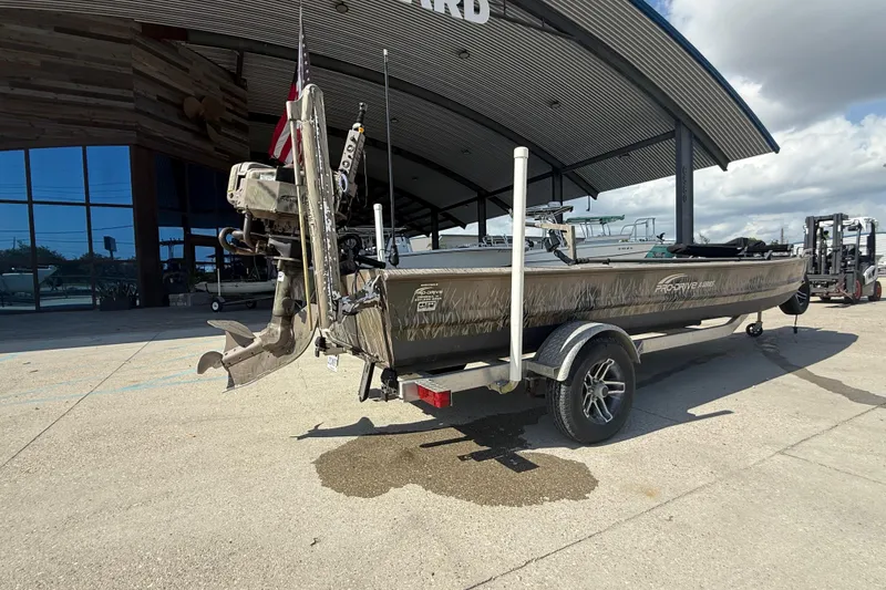 Slide: The Image of 2017 Pro-Drive 2048 boat on trailer outside a modern building, showcasing its motor and design. - 3