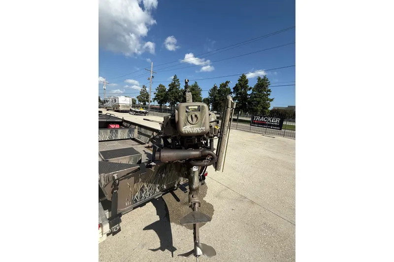 Slide: The Image of Pro-Drive 2048 boat motor, 2017 model, on a trailer under a clear blue sky. - 8