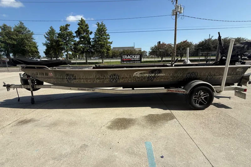 Slide: The Image of 2017 Pro-Drive 2048 boat on trailer, parked outdoors under clear sky. - 6