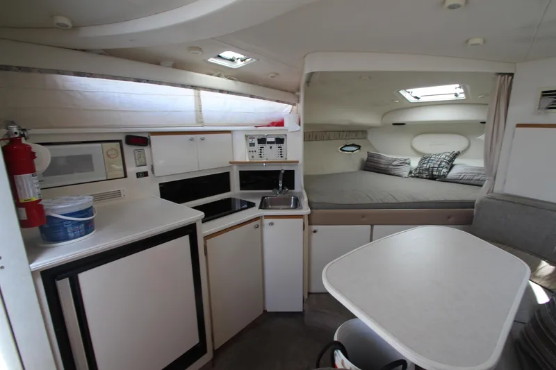 Slide: The Image of Interior of 1999 Bayliner 3055 Ciera boat with kitchenette, dining area, and sleeping quarters. - 16