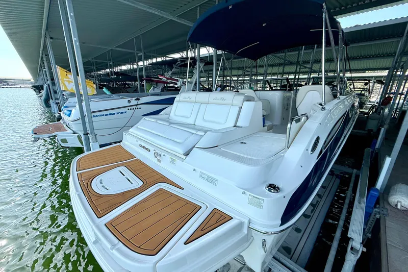 Slide: The Image of 2013 Sea Ray 260 Sundeck boat docked under a covered marina. - 8