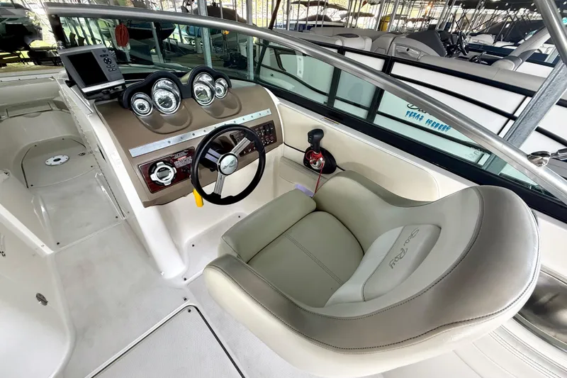 Slide: The Image of 2013 Sea Ray 260 Sundeck cockpit with steering wheel and instrument panel. - 18